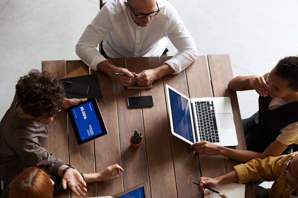 People using laptops and gadgets during a meeting