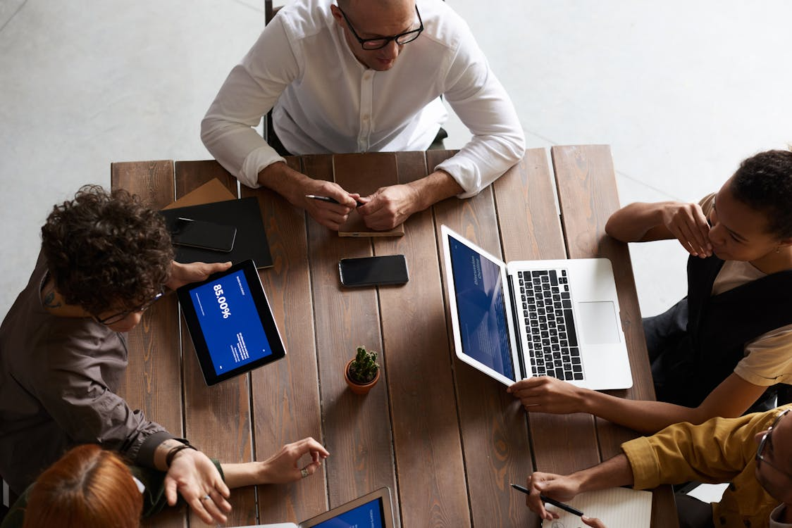 People using laptops and gadgets during a meeting