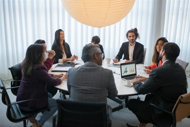 A group of people in a meeting 