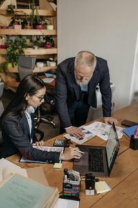 Two people discussing documents