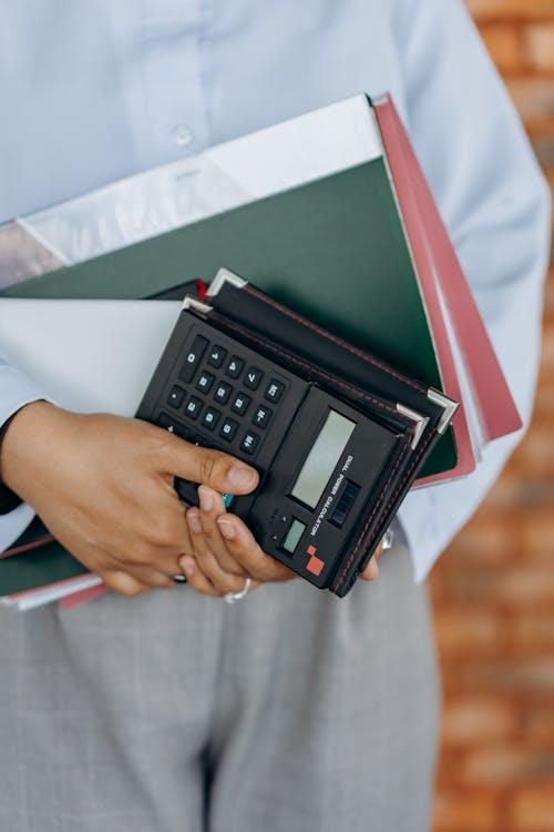 professional holding financial documents and a calculator