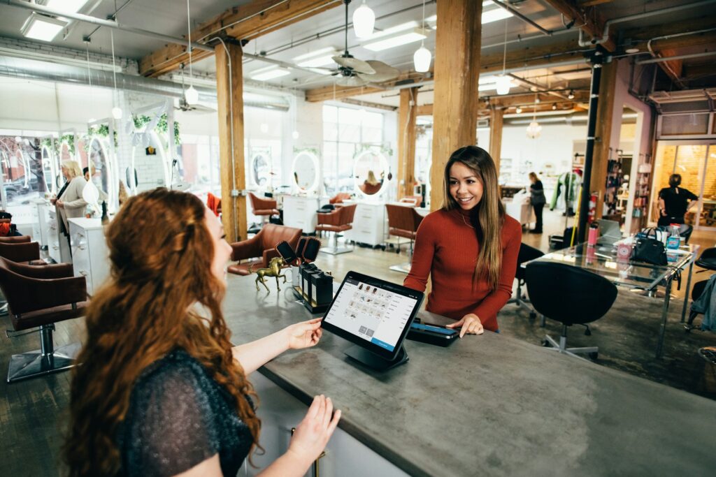 Two women at a checkout counter at a store