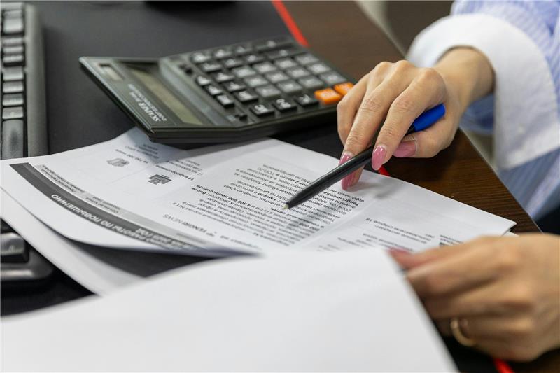 property manager reviewing financial documents with a calculator 