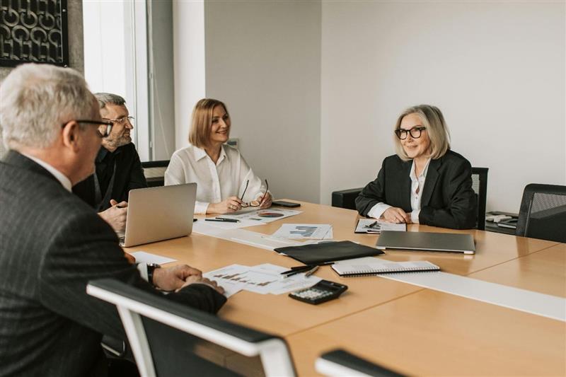 A group of people in a meeting 