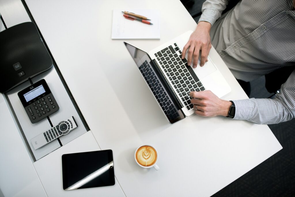 A man working on a laptop on a desk