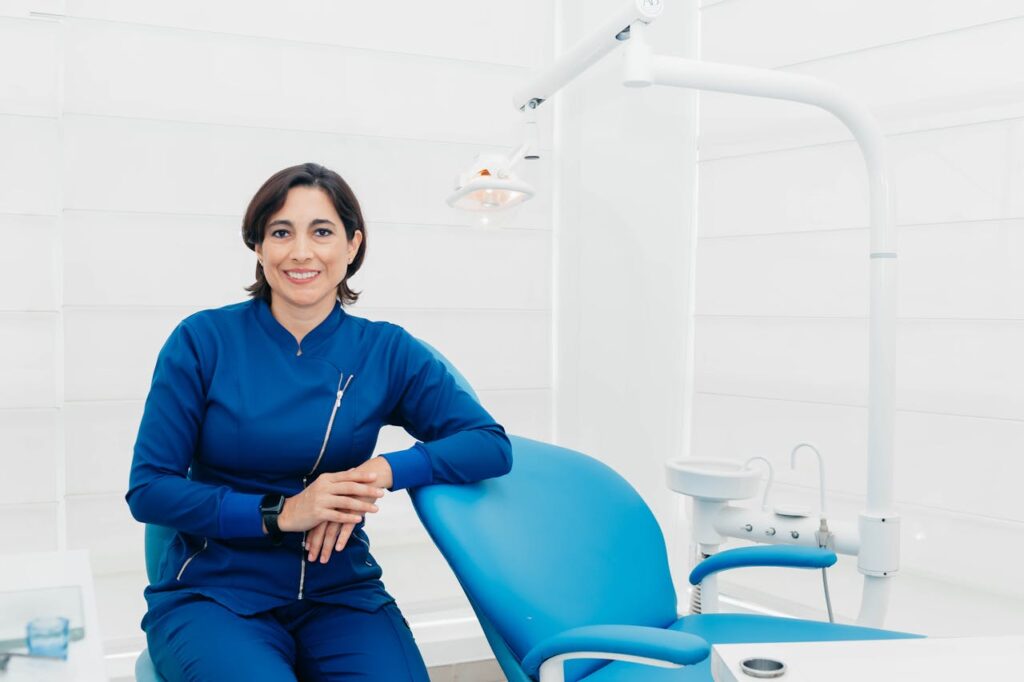 Smiling female dentist sitting