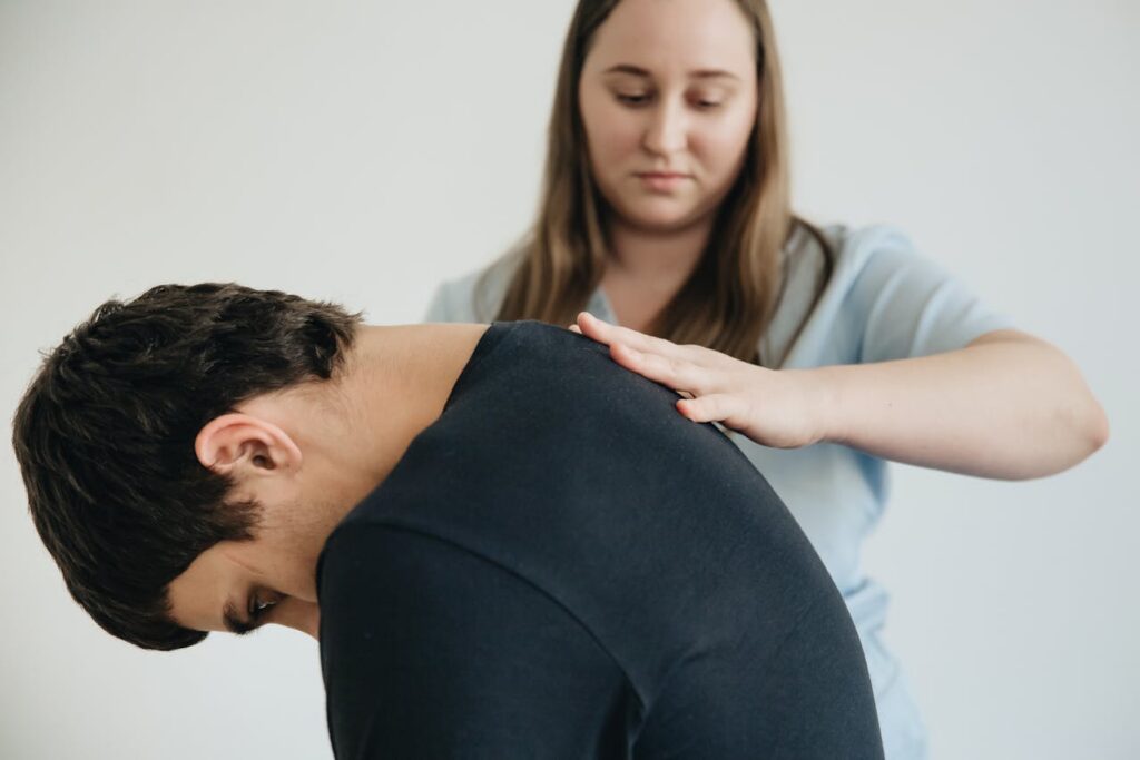 A chiropractor massaging a patient’s back
