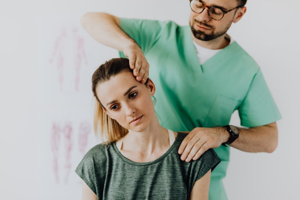 A chiropractor helping a female patient with neck pain