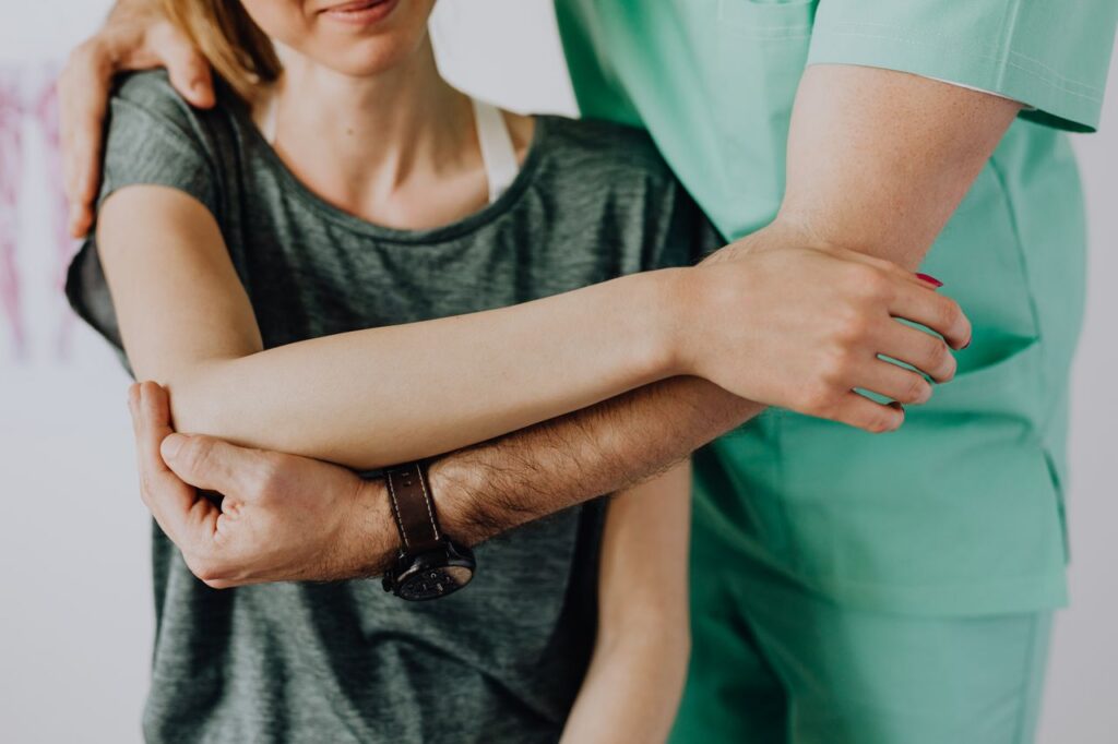 therapist aids in arm